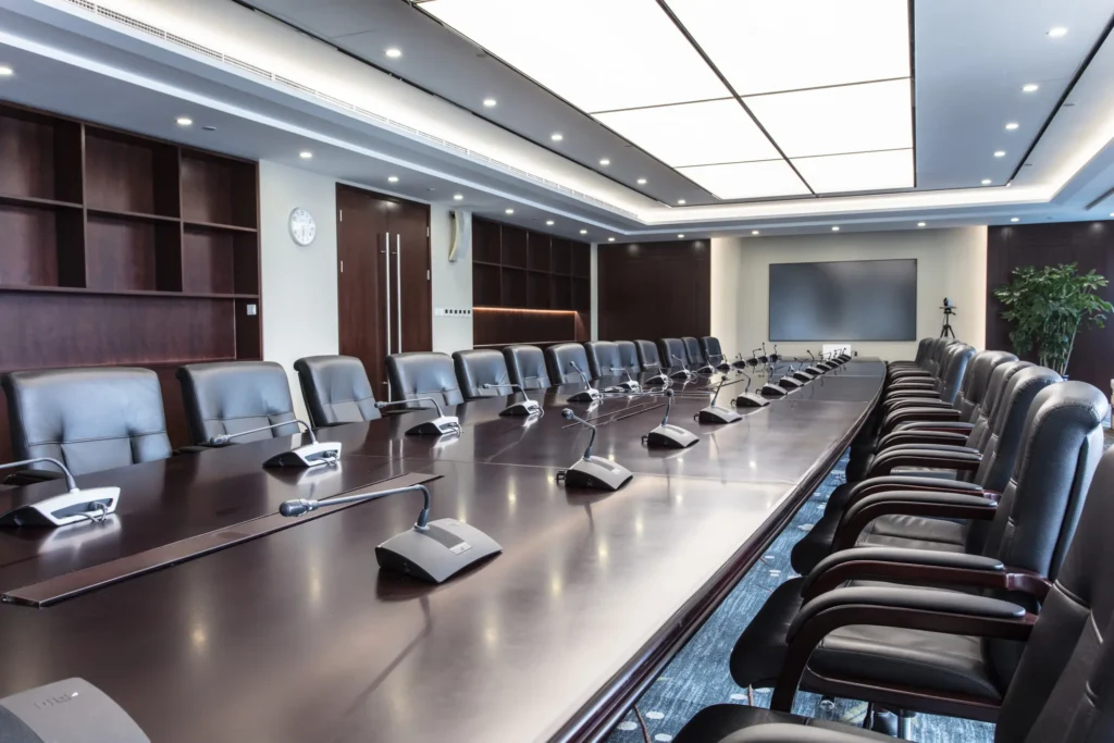 Comfortable leather chairs and neatly arranged microphones in luxurious meeting rooms